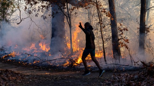 Rain may help New Jersey wildfire battle, gusts threaten to fan California fire